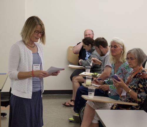 Rebekah Elliot lecturing crowd in classroom