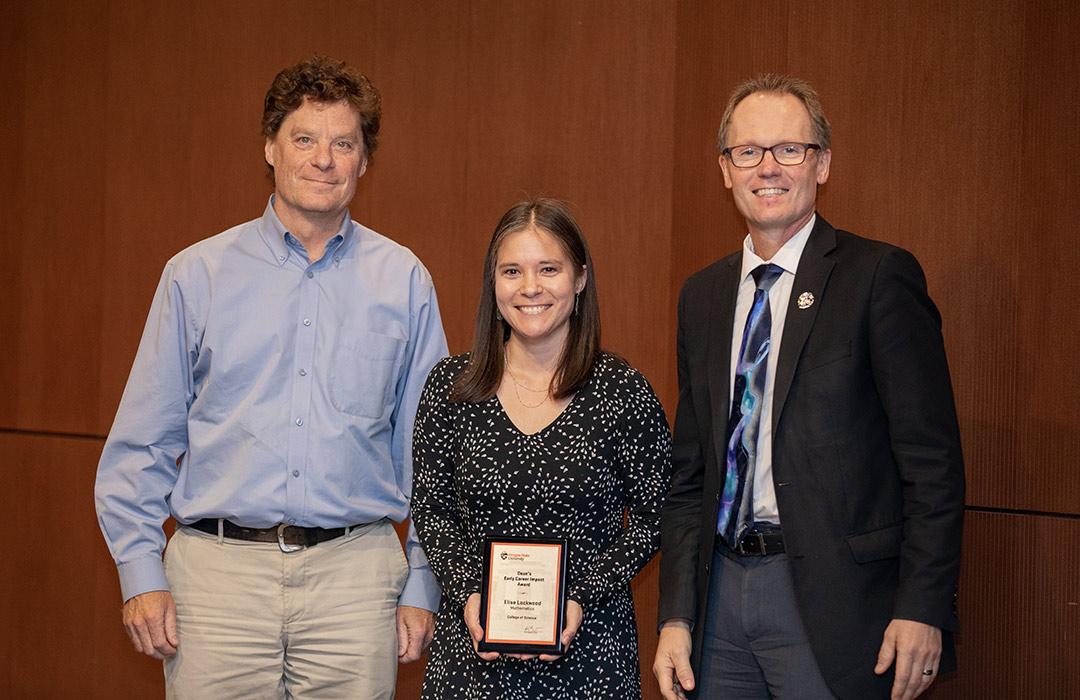 Elise Lockwood receiving award from Bill Bogley and Roy Haggerty 