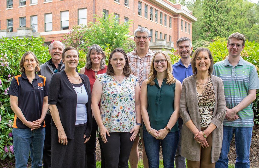 Math faculty standing together outside Kidder Hall