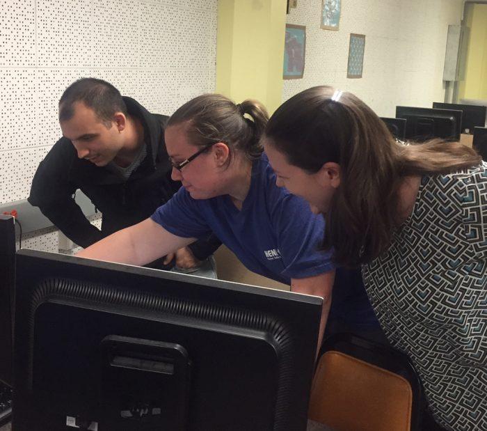 Elijah Weiss showing colleagues result on computer