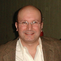 Alvaro Estevez in front of brown backdrop