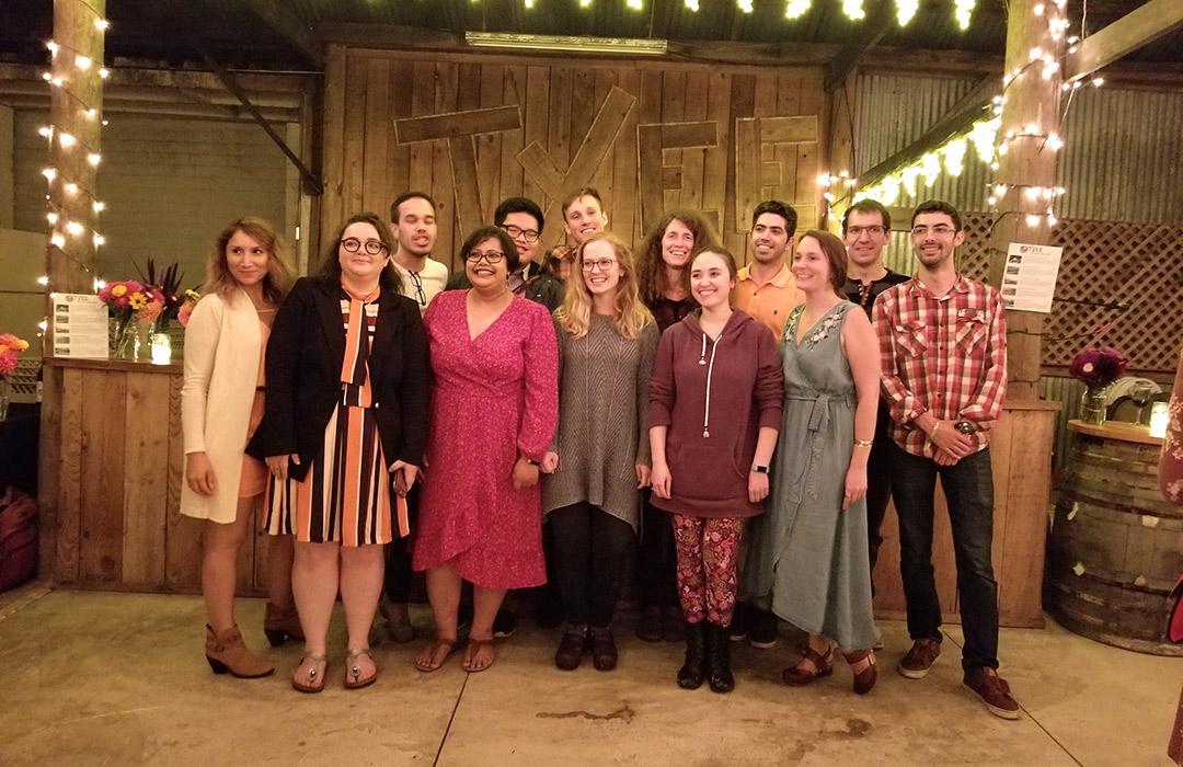 May Nyman with her team standing in barn venue