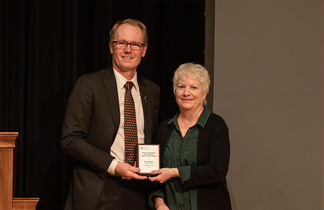 Mary Fulton receiving award from Roy Haggerty on stage