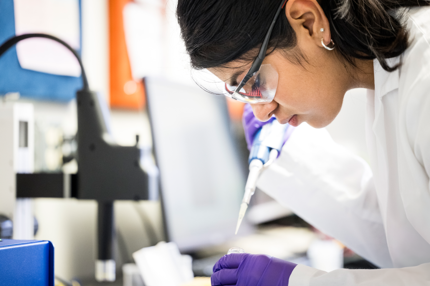 A closeup of a camper using a pipette in the lab at Oregon State University.