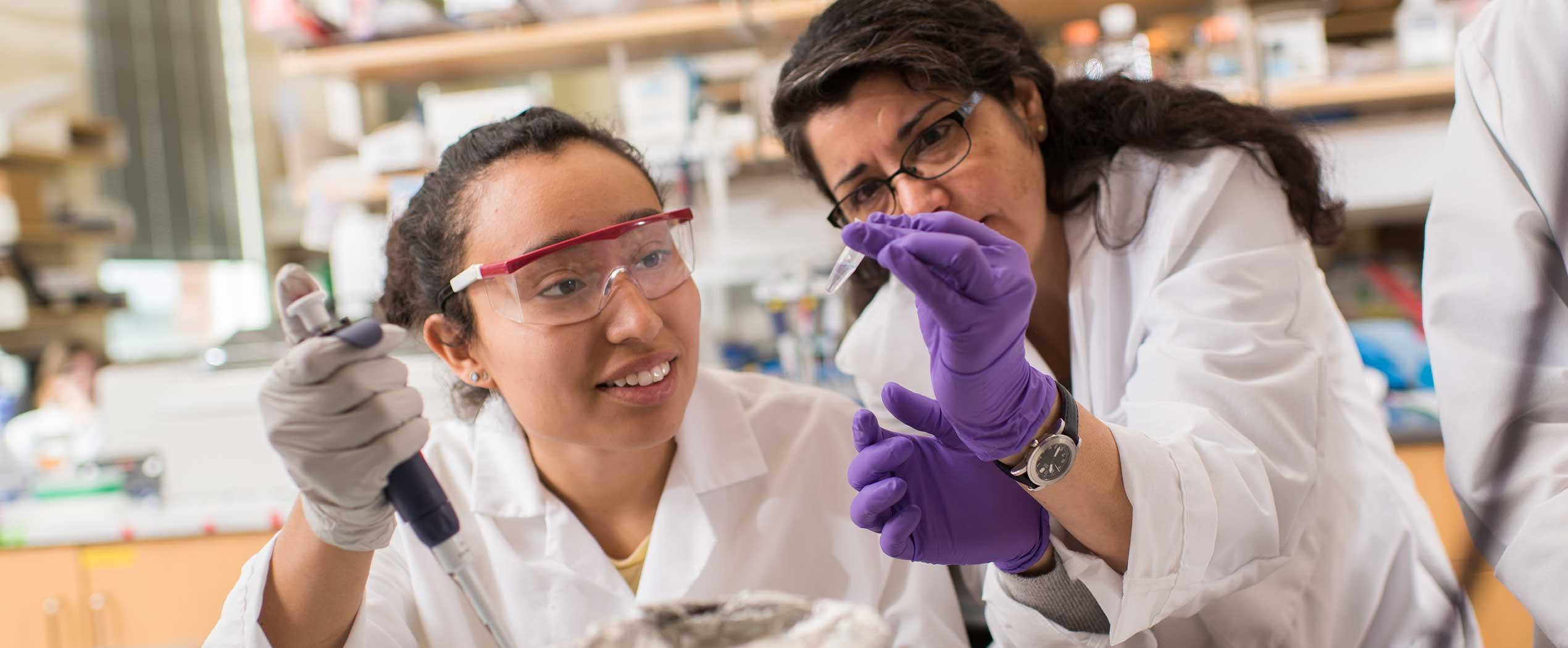 Luz Jovita Dimas with Viviana Perez analyzing samples in lab