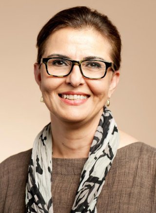 Headshot of a smiling woman in glasses