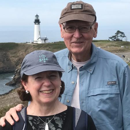 Ron and Ann Berg in front of Yaquina Head Lighthouse in Newport, OR