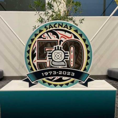 A turquoise podium with a SACNAS figure showing the years 1973 to 2023.