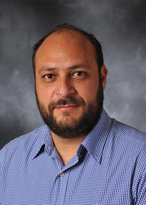 Kyriakos Stylianou in front of grey backdrop