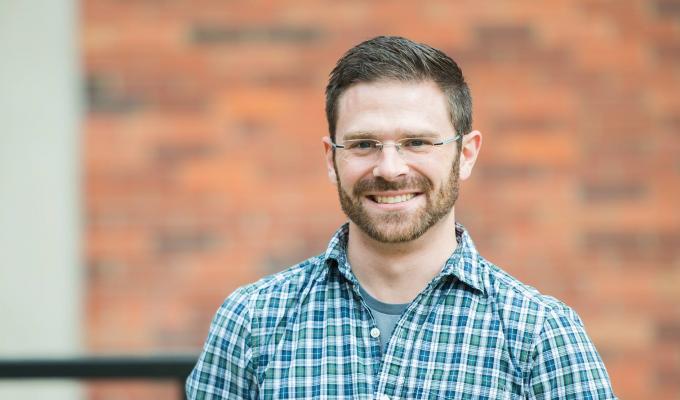 David Koslicki standing in front of brick wall