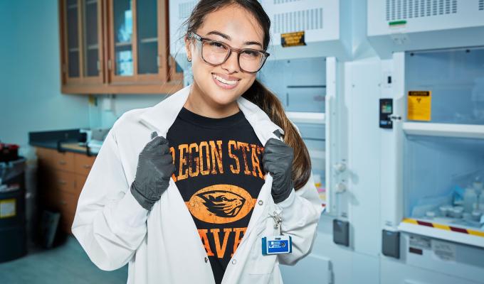 Jenna Bustos showing off her Oregon State shirt while in the lab.