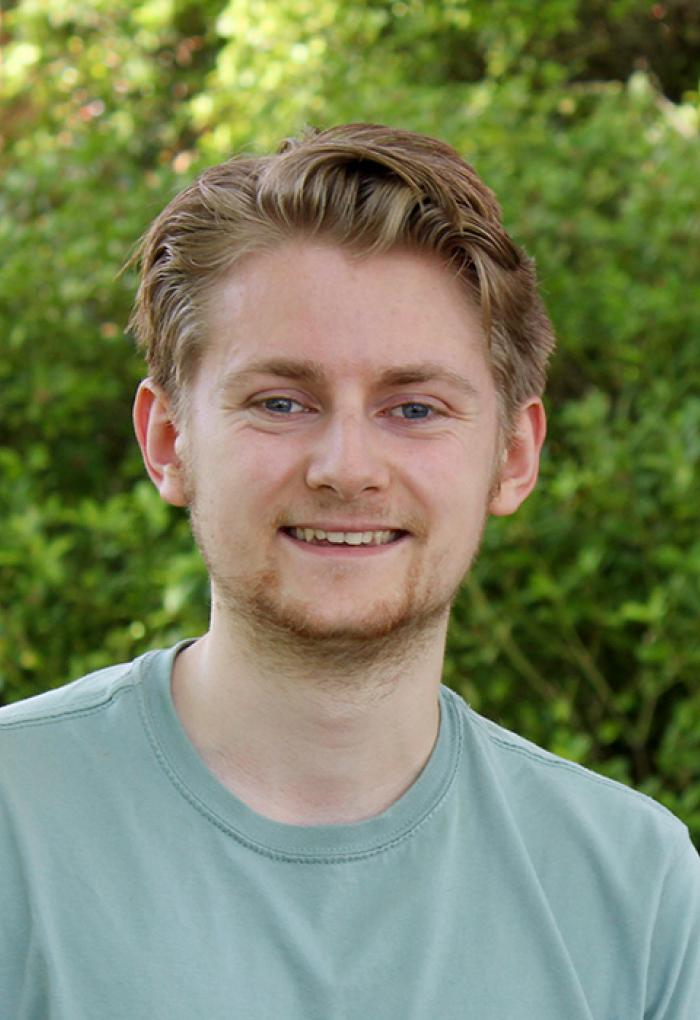 Ryan Tollefsen in front of Kidder Hall