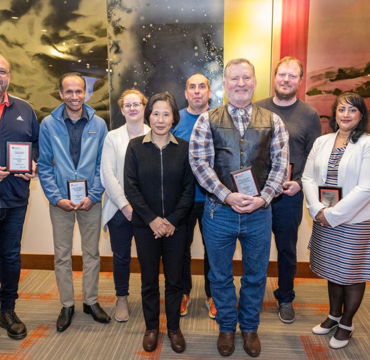 Participants pose for a group photo and display their plaques at the 2024 Winter Awards Ceremony at Oregon State University.