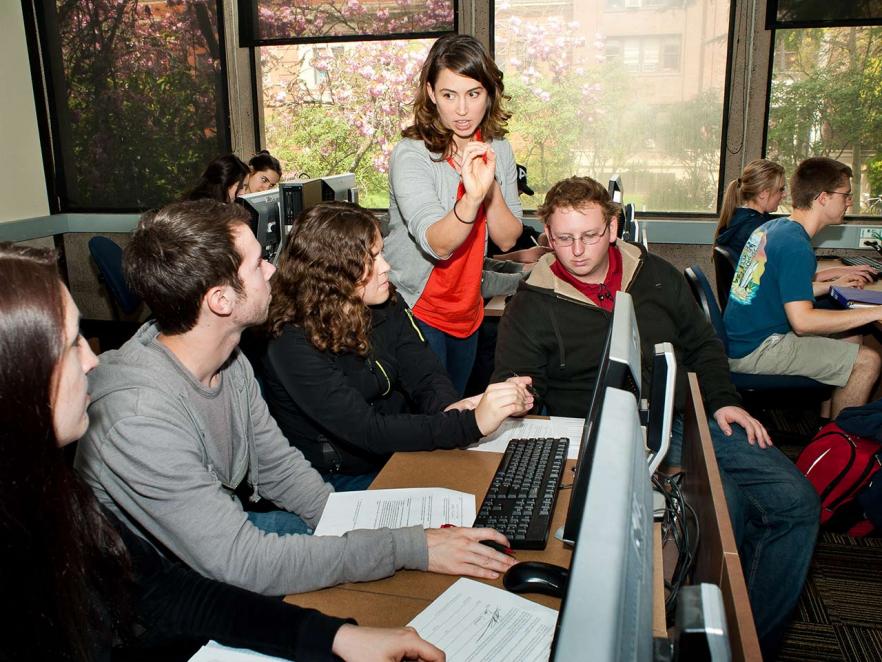 professor helping students in computer lab